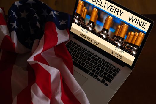 laptop with wine delivery and usa flag.