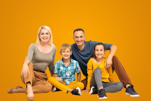 Happy father and mother with little children sitting.