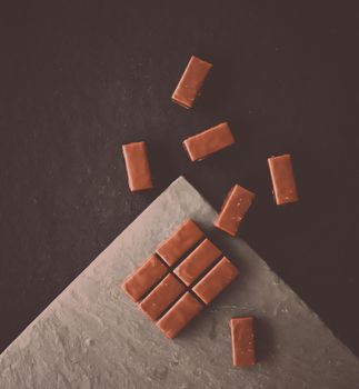 Sweet swiss chocolate candies on a stone tabletop, flatlay - desserts, confectionery and gluten-free organic food concept. All you need is chocolate