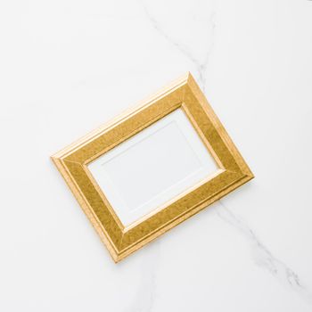 Golden photo frame on marble, flatlay - modern feminine, artwork mock up, luxury design concept. Decorate with chic and style