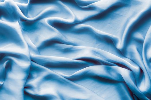 Blue soft silk waves, flatlay - elegant fabric textures, abstract backgrounds and modern pastel colours concept. Feel the touch of luxury