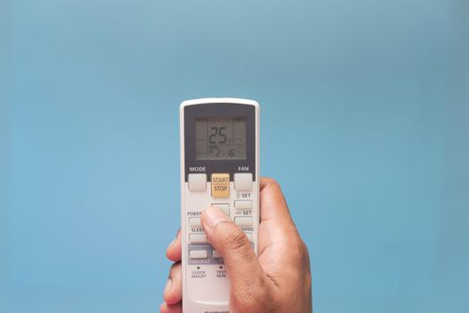 Close up of man hand holding air condition remote