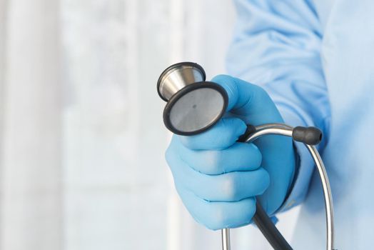 Close up of doctor hand using stethoscope