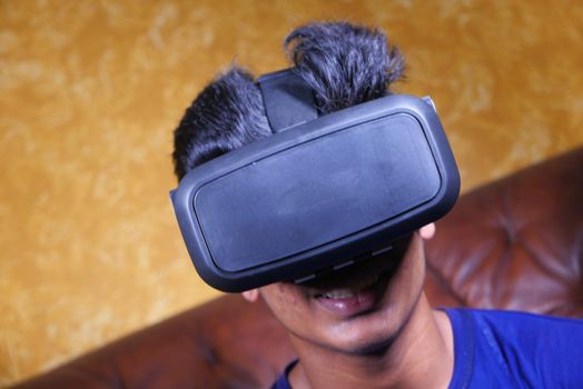 young man wearing virtual reality headset, close up