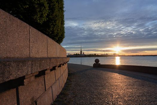 Spit of Vasilyevsky Island. View of the Peter and Paul Fortress. St. Petersburg. Neva River at summer sunrise.