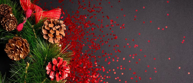 Christmas wreath with red glitter on black background with copy space