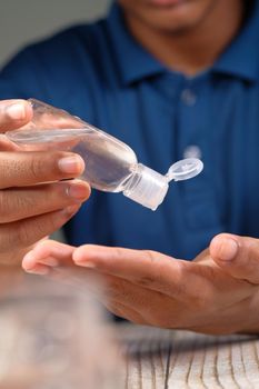 close up of young man hand using sanitizer gel for preventing virus.