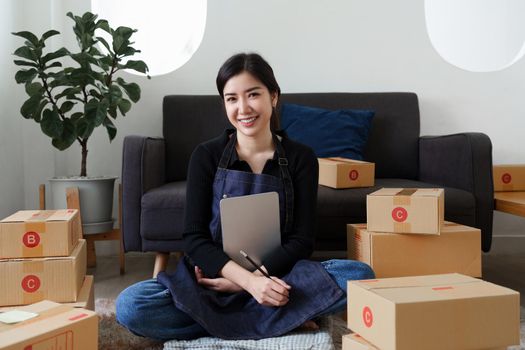 Happy Asian SME business woman working at home office. online shopping concept.