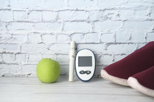 diabetic measurement tools, apple on table .