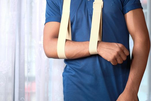 young man wearing an arm brace for broken hand