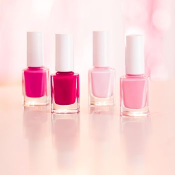 Shades of pink and red nail polish set on glamour background, nailpolish bottles for manicure and pedicure, luxury beauty cosmetics and make-up brand ad