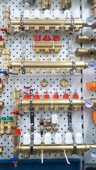 Various collectors of water heating and other equipment for domestic water heating systems on a stand in a store.