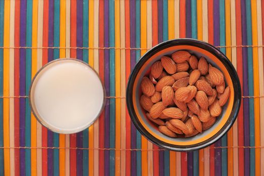 almond nut and milk on table top down.