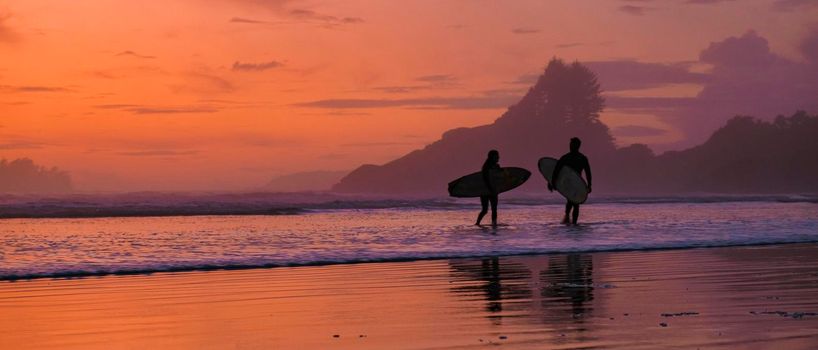 Tofino Vancouver Island Pacific rim coast, surfers with surfboard during sunset at the beach, surfers silhouette Canada Vancouver Island Tofino Vancouver Islander Island