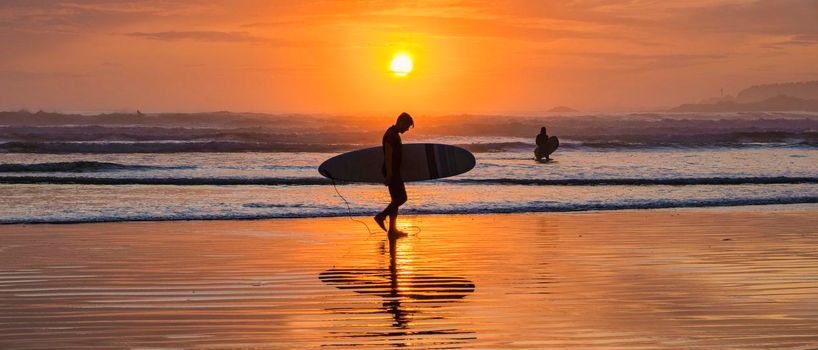 Tofino Vancouver Island Pacific rim coast, surfers with surfboard during sunset at the beach, surfers silhouette Canada Vancouver Island Tofino Vancouver Islander Island