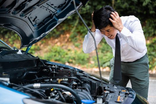 Asian businessman car broken breakdown, young stressed man having trouble car failure problem looking in frustration at failed engine in the morning, accident on road outdoor, late for work