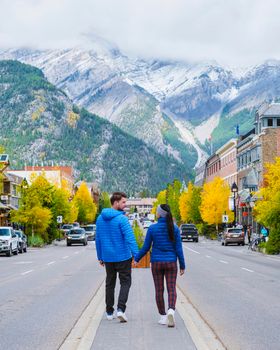 Banff village in Banff national park Canada Canadian Rockies during Autumn fall season. Couple of men and women on vacation in Banff Canada between the mountains