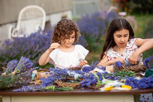 Girls make homemade lavender wreaths as a decor for home or present