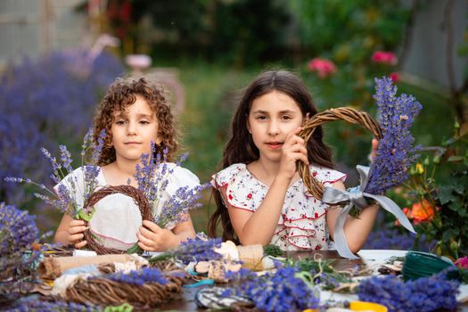 Girls make homemade lavender wreaths as a decor for home or present