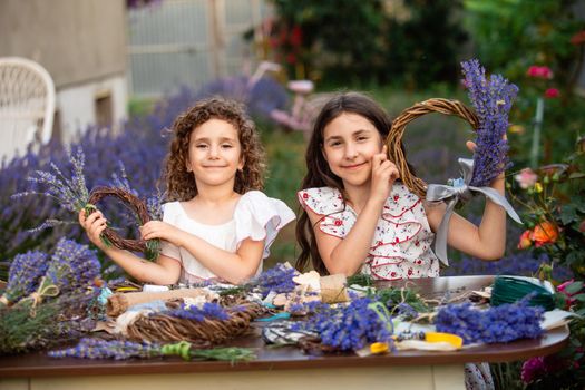 Girls make homemade lavender wreaths as a decor for home or present