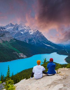 Lake Peyto in Banff National Park, Canada. Mountain Lake as a fox head is popular among tourists in Canada driving the icefields parkway. A couple of men and women looking out over the lake