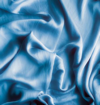 Blue soft silk waves, flatlay - elegant fabric textures, abstract backgrounds and modern pastel colours concept. Feel the touch of luxury