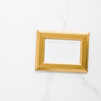 Golden photo frame on marble, flatlay - modern feminine, artwork mock up, luxury design concept. Decorate with chic and style