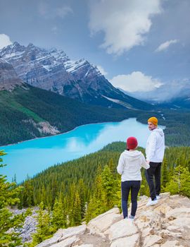 Lake Peyto in Banff National Park, Canada. Mountain Lake as a fox head is popular among tourists in Canada driving the icefields parkway. A couple of men and women looking out over the lake