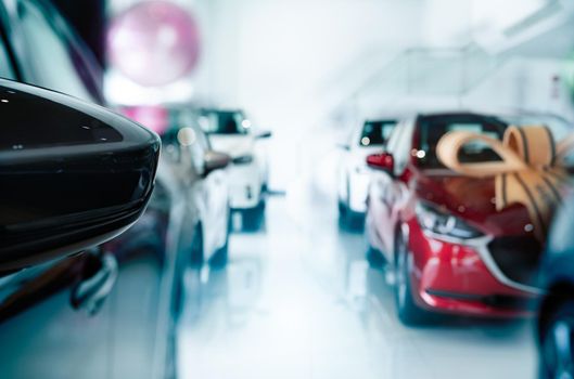 Car parked in luxury showroom. New car parked in modern showroom. Car dealership office. Automobile leasing and insurance concept. Automotive industry. Auto leasing business. Electric vehicle dealer.