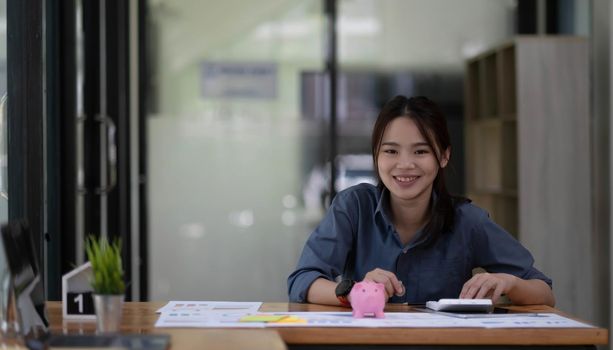 Shot of a asian young business Female working on laptop computer in her workstation.Portrait of Business people employee freelance online marketing e-commerce telemarketing concept..