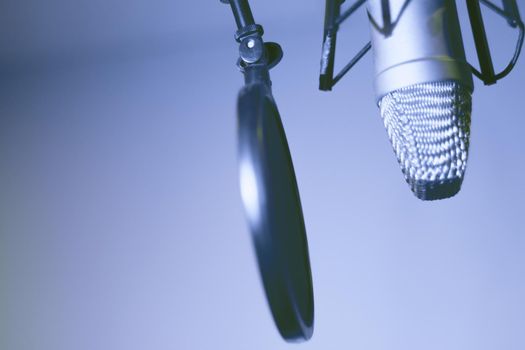 Professional microphone suspended in the air of professional studio