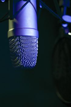 Professional microphone suspended in the air of professional studio