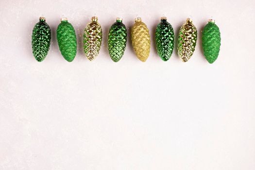 Christmas decoration in a form of pine cones on white background, top view, copy space