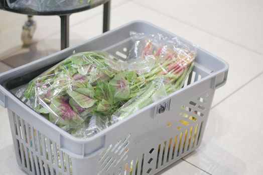 Shopping cart full of food in the supermarket .