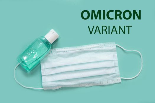 Medical mask and antiseptic on a white background with B.1.1.529 omicron variant text . A new variant of the coronavirus was discovered in South Africa in November 2021