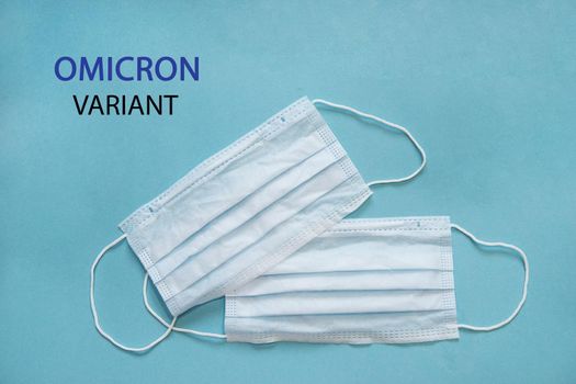 Medical protective mask on a blue background with B.1.1.529 omicron variant text . A new variant of the coronavirus was discovered in South Africa in November 2021. Virus prevention and treatment.