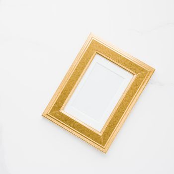 Golden photo frame on marble, flatlay - modern feminine, artwork mock up, luxury design concept. Decorate with chic and style