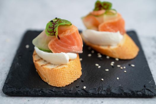 Sandwich with bread salmon slices and soft cheese
