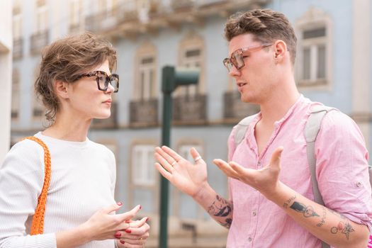 Young beautiful hipster couple in love walking on old city street, summer Europe vacation, travel, fun, happy, smiling, glasses, trendy outfit, romance, date, embracing