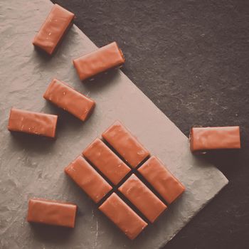 Sweet swiss chocolate candies on a stone tabletop, flatlay - desserts, confectionery and gluten-free organic food concept. All you need is chocolate