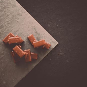 Sweet swiss chocolate candies on a stone tabletop, flatlay - desserts, confectionery and gluten-free organic food concept. All you need is chocolate