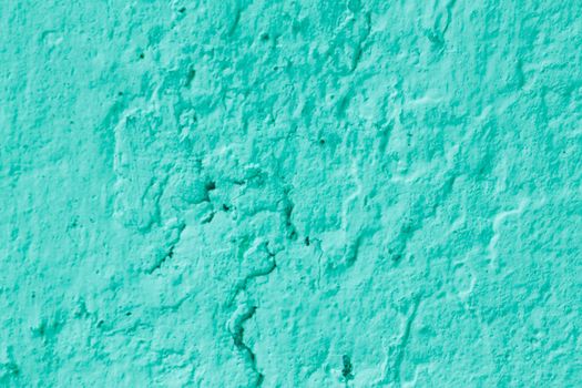 Old plaster damaged by time. The surface of the old plaster of green bright color.