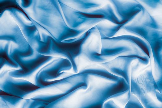 Blue soft silk waves, flatlay - elegant fabric textures, abstract backgrounds and modern pastel colours concept. Feel the touch of luxury