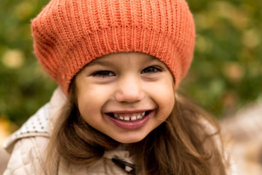 Close Up Portrait Of Little Cute Preschool Minor Girl In Orange Beret On Yellow Fallen Leaves Nice Smiling Looking At Camera In Cold Weather In Fall Park. Childhood, Family, Motherhood, Autumn Concept.