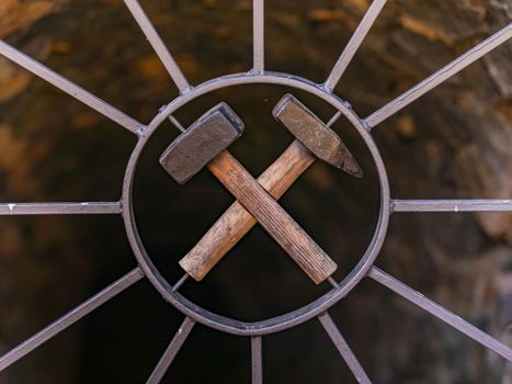 Crossed hammers on a door in front of an old mine in Germany