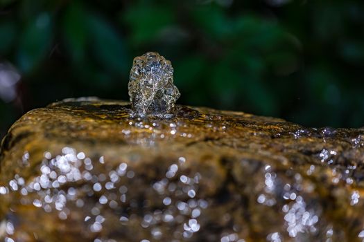 Water from a well exposed and frozen in the continuous movement through the shot