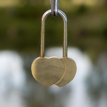 heart shaped padlock on a blurred background