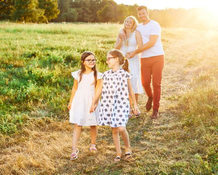 Portrait of a young happy family having fun outdoors