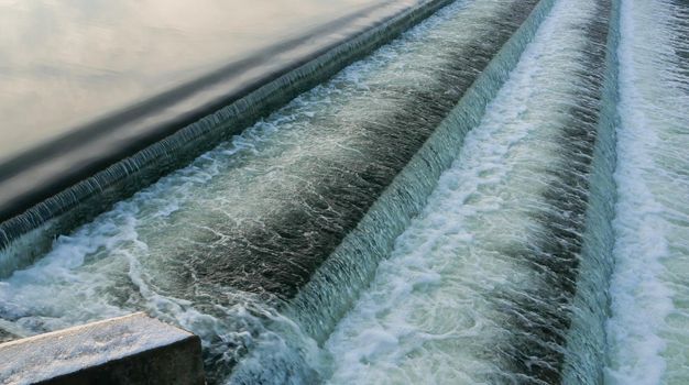 Cascade of falling water on the reservoir. High quality photo