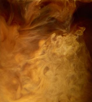 Close up of coffee and milk mixing in a glass cup background